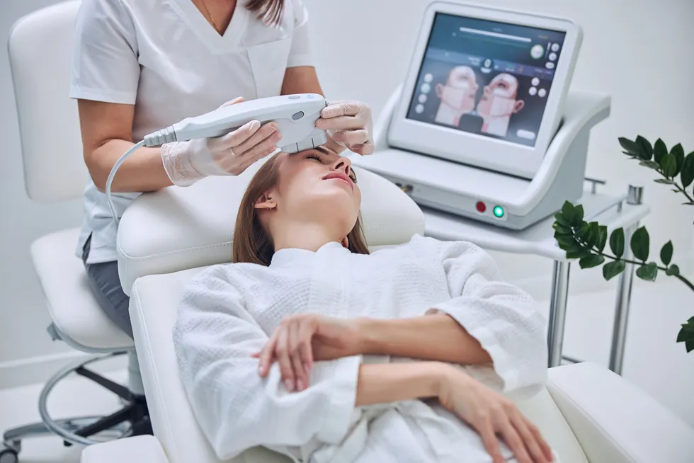 A patient receiving a skin rejuvenation treatment in a clinic chair