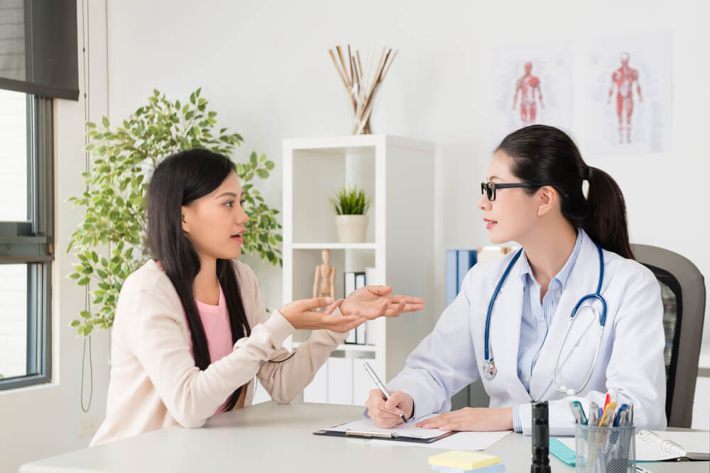 Young woman consulting her doctor for Dermal fillers