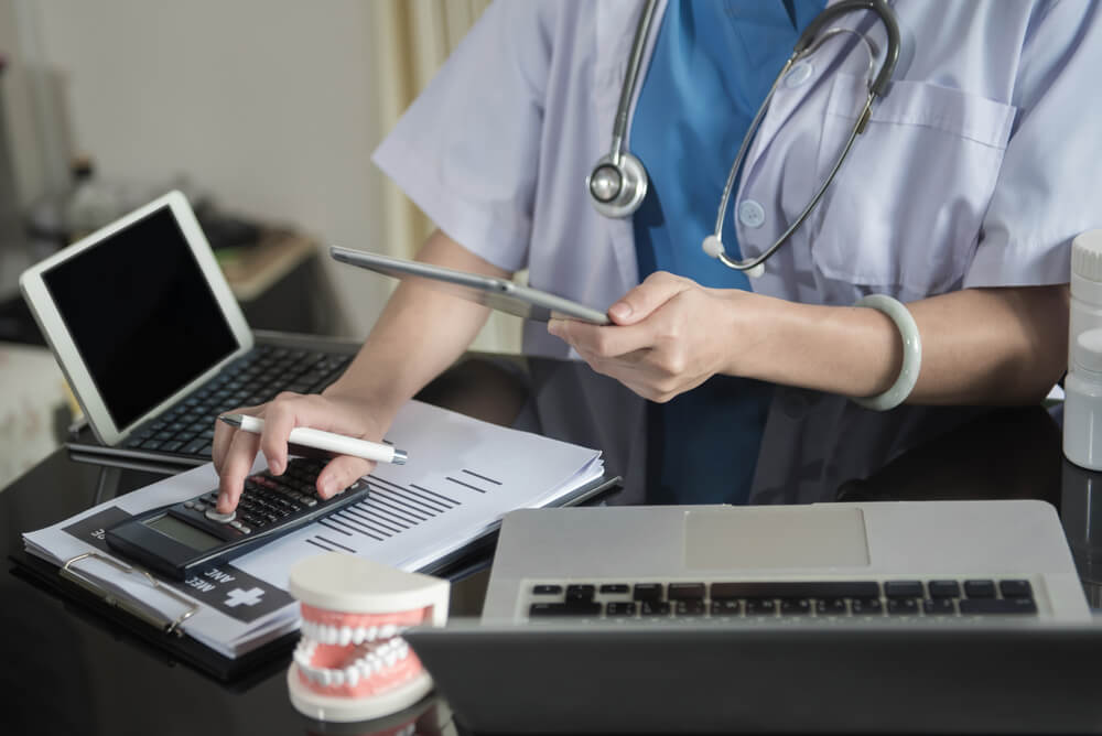 doctor on a close-up using calculator