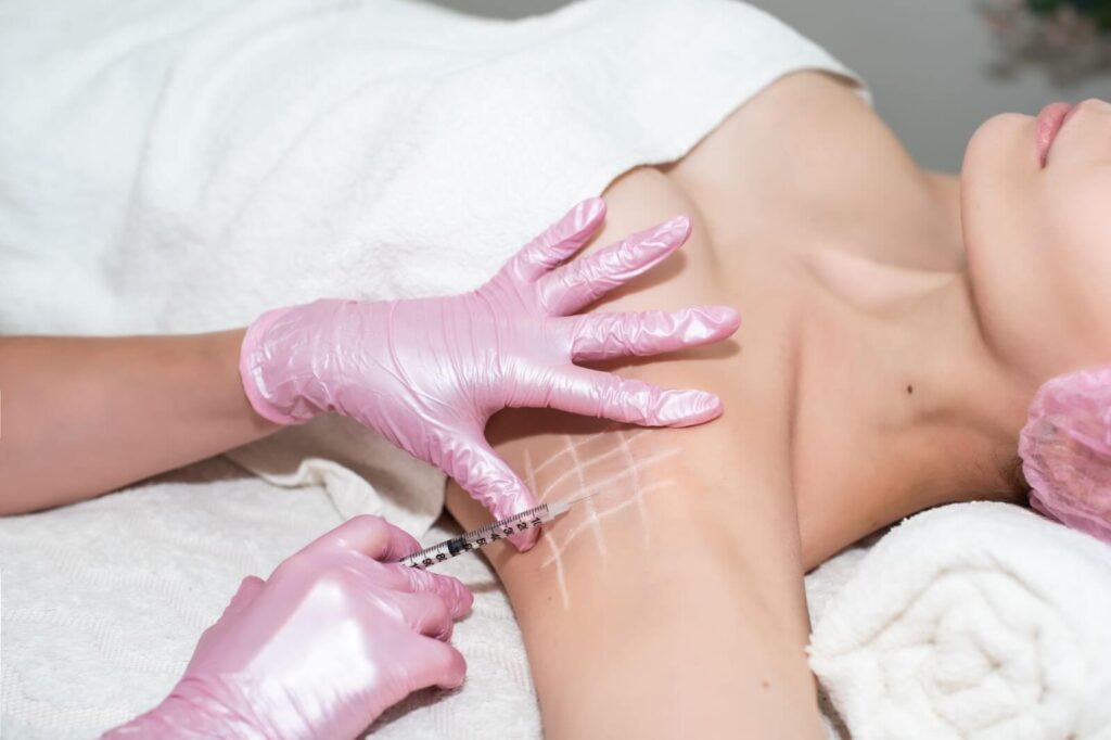 injecting Botox on woman armpit