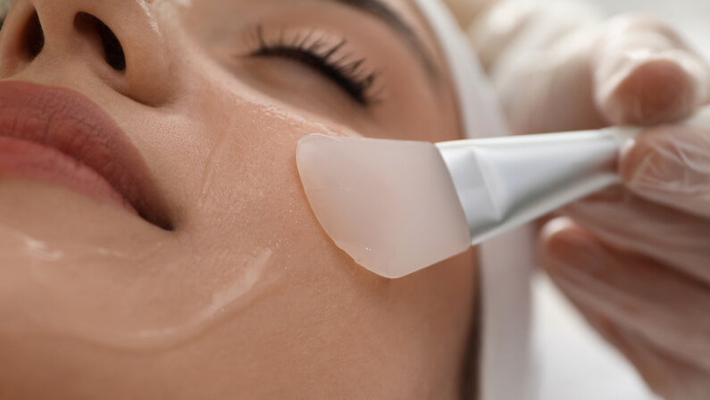 applying chemical peel to a client