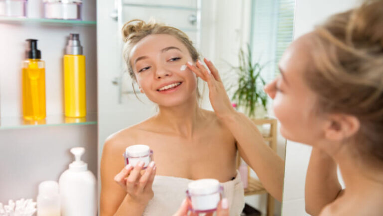 young lady applying skincare